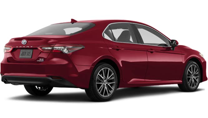 A photo of a 2023 Toyota Camry Hybrid XLE sedan with the red exterior paint color option, taken from a passenger side back corner angle