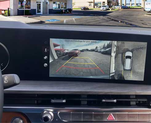 A close up picture of the dashboard media screen of a 2023 Kia Telluride while in backup camera mode
