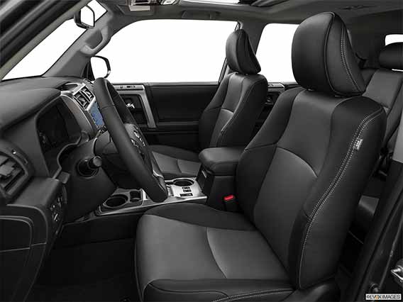 A picture looking in through the open front drivers side door of a Toyota 4runner with the profile of the steering wheel and the front seats in view.