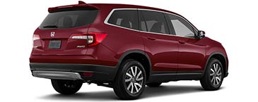 A picture of the 2022 Honda Pilot EX-L with the red Deep Scarlet Pearl exterior pain color option, taken from a back-passenger side angle